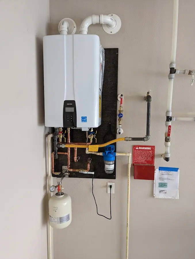 Professional plumber installing copper piping in a Wolf Trap home